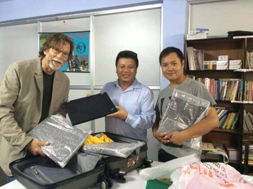 Michael Burak delivering laptops to HELP's Jimmy Lama and Chiring Lama, September 2015
